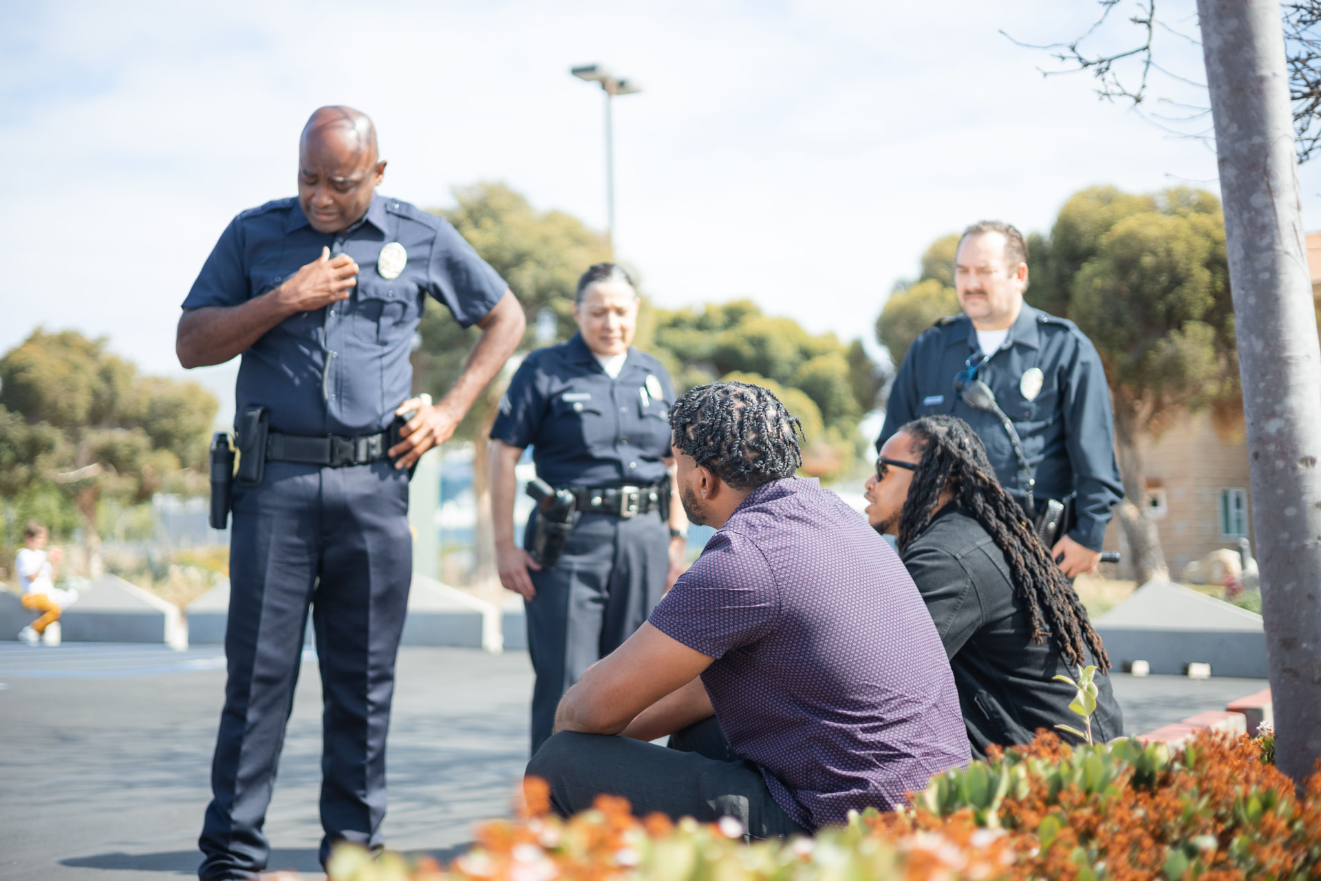 Police officers speaking with community members outdoors